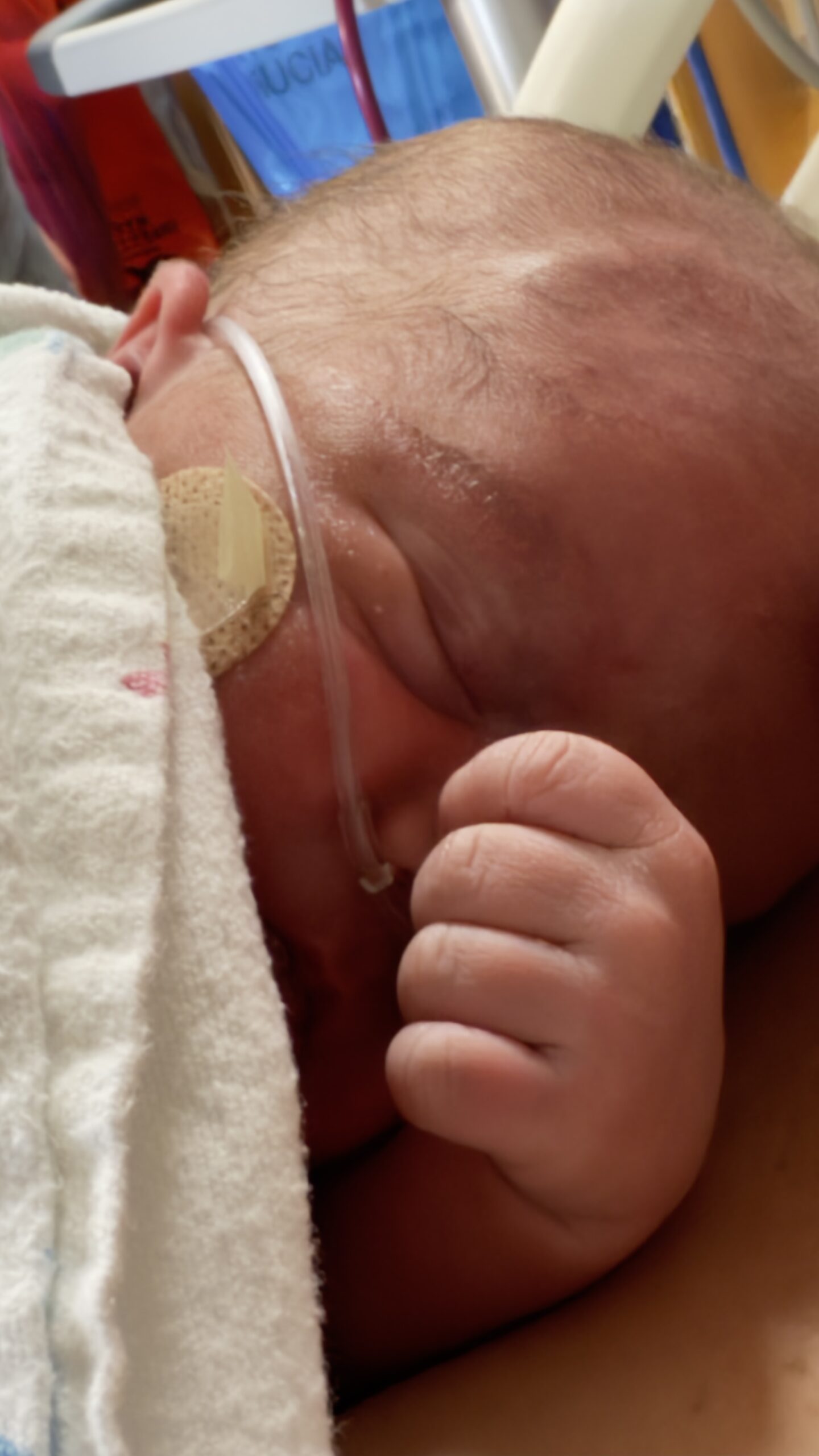 Newborn Henry on his mom's chest moments after birth, taken by grandma in the delivery room.